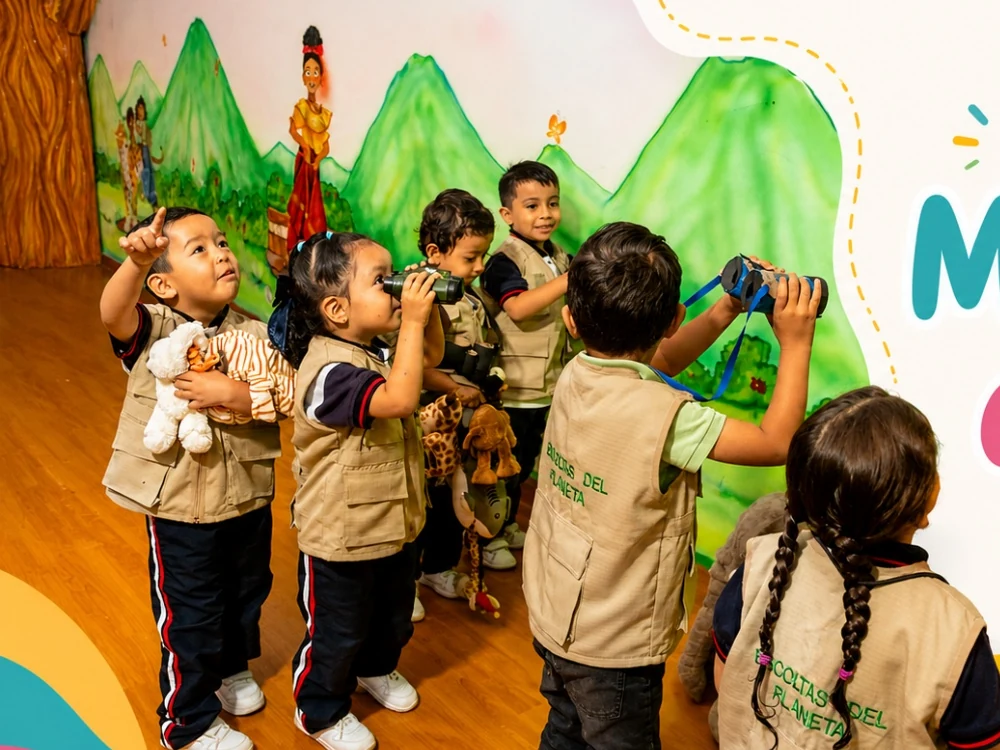 Niños del Preescolar Sonrisas Infantiles participando en una actividad de exploración con binoculares